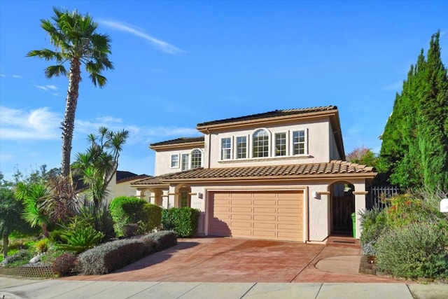 mediterranean / spanish-style home with a garage