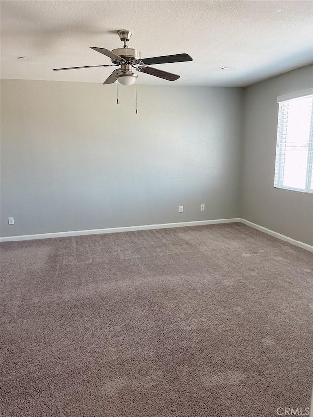 spare room with carpet floors and ceiling fan