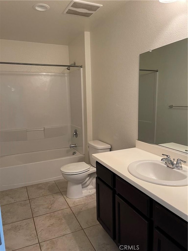 full bathroom with toilet, vanity, tile patterned floors, and shower / washtub combination