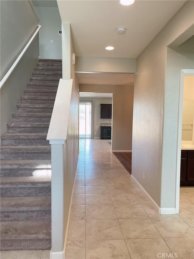 stairway featuring tile patterned floors