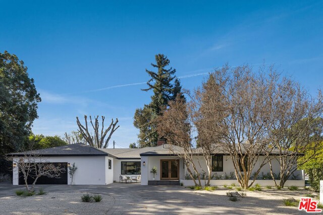 ranch-style home featuring a garage