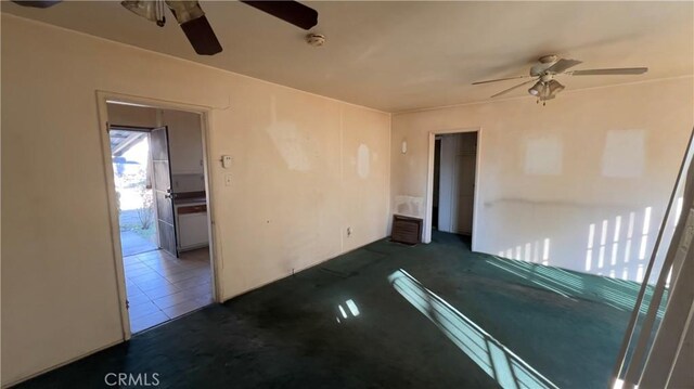 carpeted empty room with ceiling fan