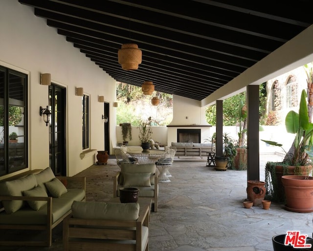 view of patio / terrace with an outdoor living space with a fireplace