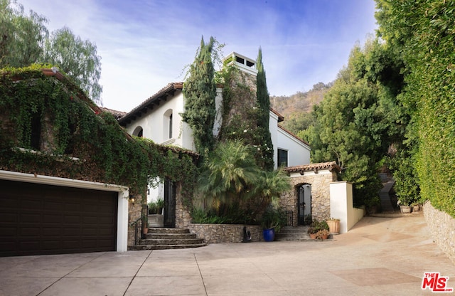 mediterranean / spanish house with a garage