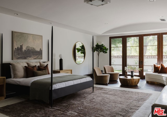 bedroom with lofted ceiling and hardwood / wood-style floors