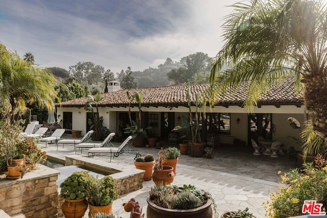 rear view of property featuring a patio