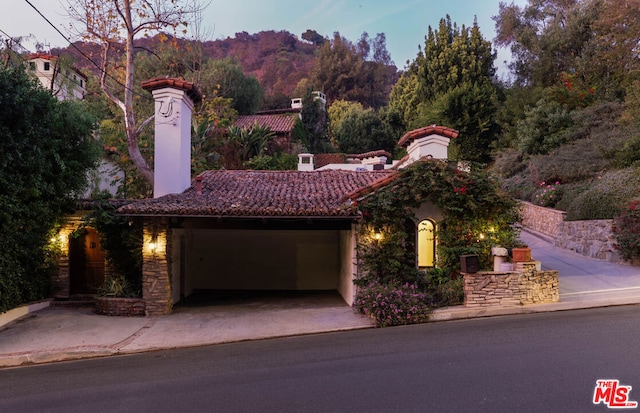 mediterranean / spanish home with a mountain view and a garage