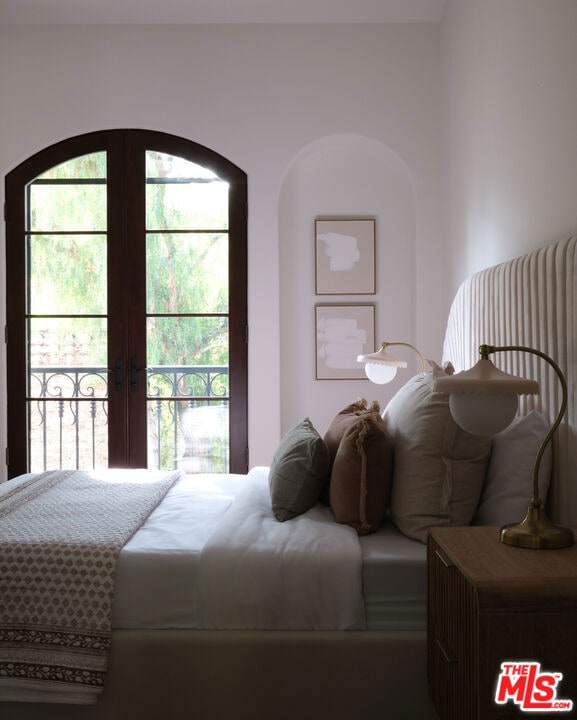 bedroom featuring multiple windows and french doors