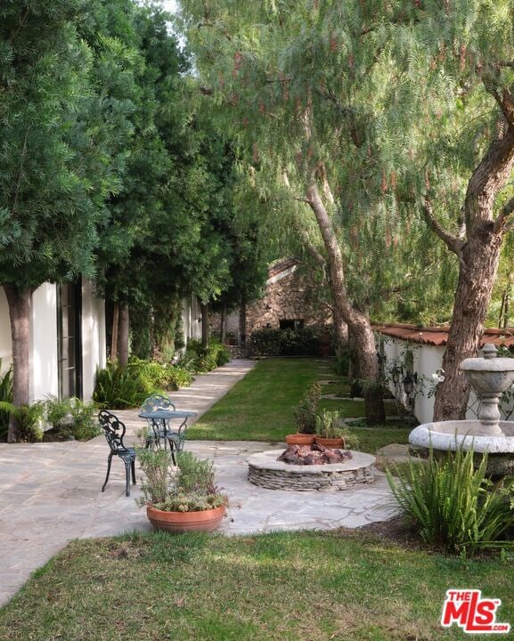 view of yard with an outdoor fire pit and a patio