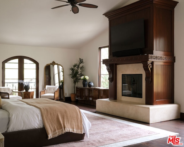 bedroom featuring ceiling fan, hardwood / wood-style floors, and lofted ceiling