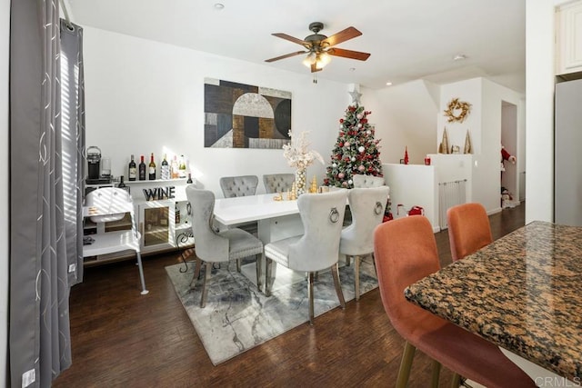 dining room with dark wood-type flooring and ceiling fan