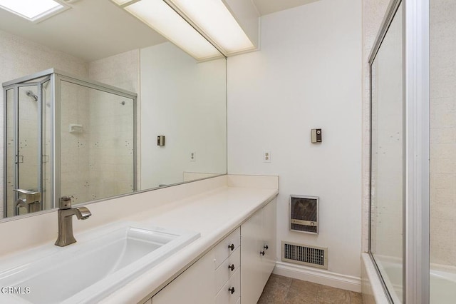 bathroom featuring vanity, tile patterned floors, and a shower with door