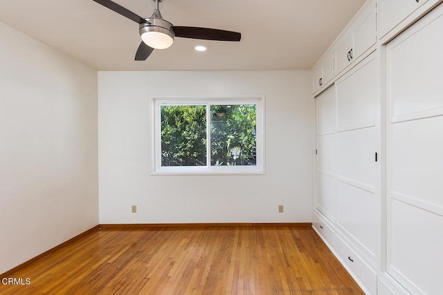 unfurnished bedroom with ceiling fan, a closet, and light wood-type flooring