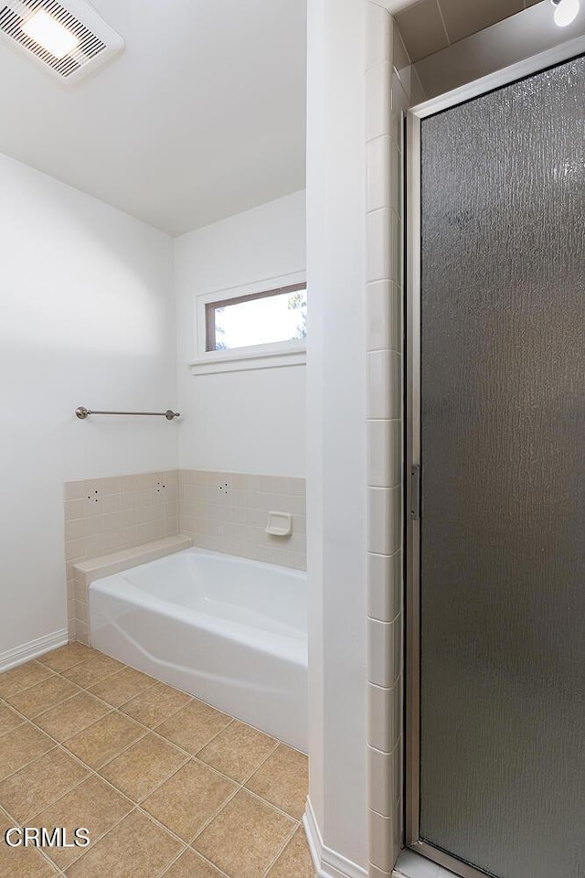 bathroom with tile patterned floors and plus walk in shower