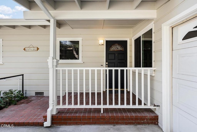 doorway to property featuring covered porch