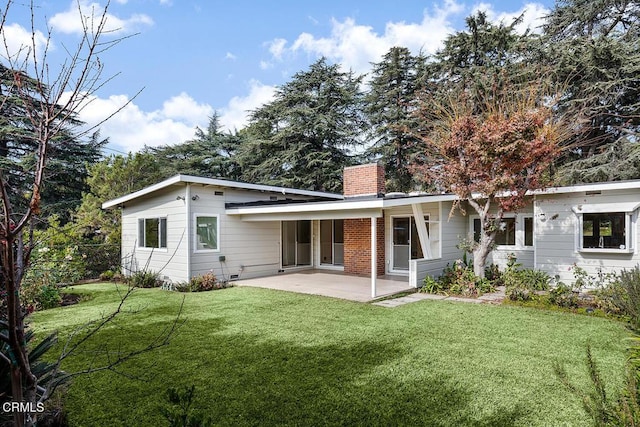 rear view of property featuring a yard and a patio