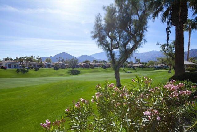 surrounding community featuring a yard and a mountain view