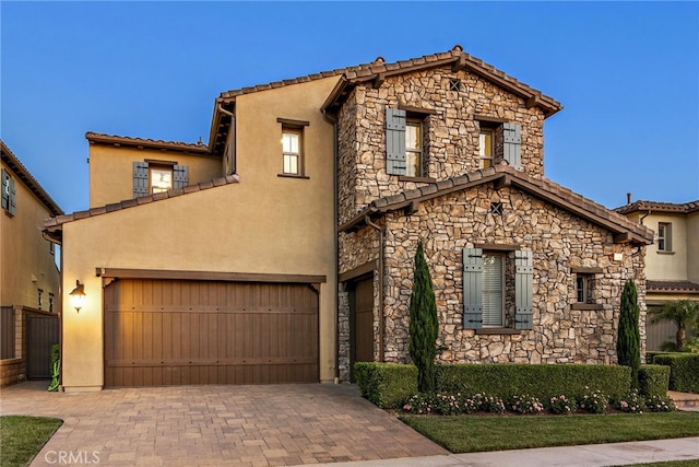 mediterranean / spanish-style home featuring a garage