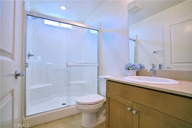 bathroom featuring toilet, tile patterned floors, a shower with shower door, and vanity