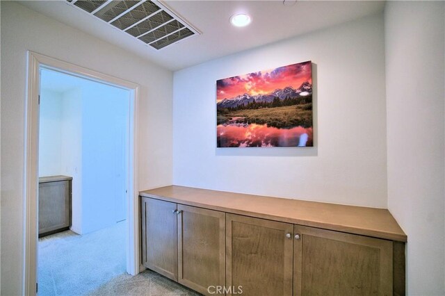 hallway with light colored carpet