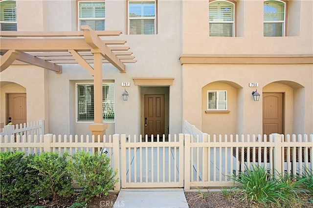 doorway to property featuring a pergola