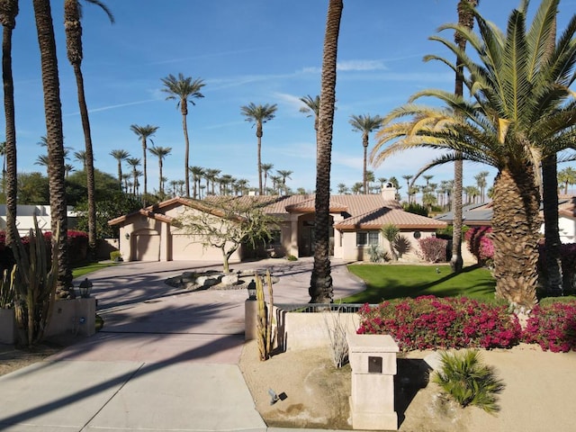 mediterranean / spanish house with a front lawn and a garage