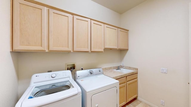 laundry room with sink, separate washer and dryer, and cabinets