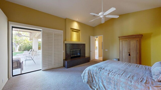 bedroom featuring ceiling fan, light colored carpet, access to outside, and a fireplace