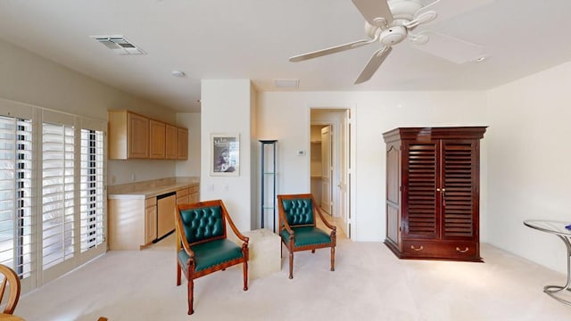 living area featuring ceiling fan and light colored carpet