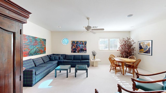 carpeted living room featuring ceiling fan