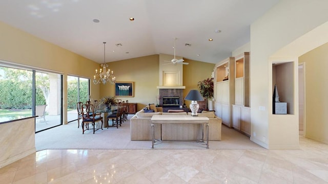 living room with ceiling fan with notable chandelier, a large fireplace, and lofted ceiling