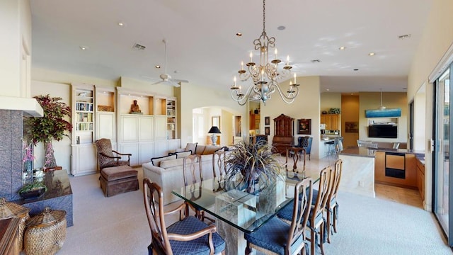 dining area with ceiling fan with notable chandelier and light carpet