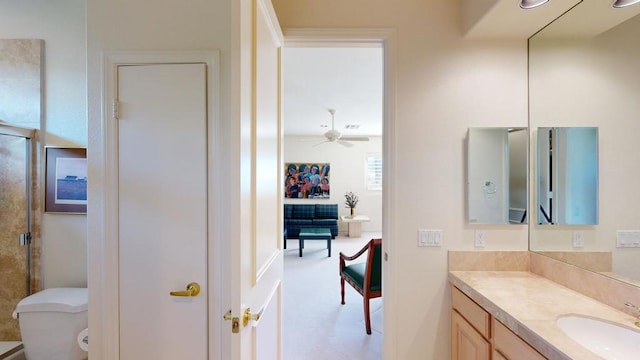 bathroom with toilet, ceiling fan, an enclosed shower, and vanity