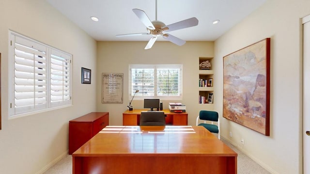 carpeted office featuring ceiling fan and built in features