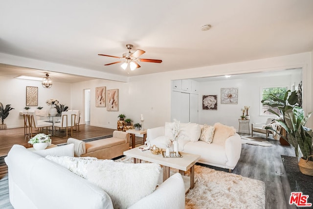 living room featuring ceiling fan and hardwood / wood-style floors