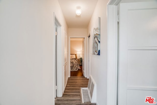 corridor featuring dark hardwood / wood-style floors