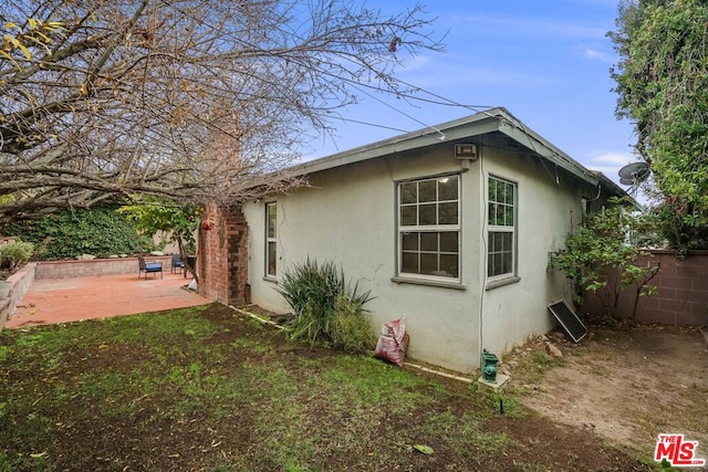 view of property exterior featuring a patio area