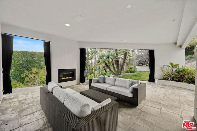 view of patio / terrace with an outdoor living space with a fireplace