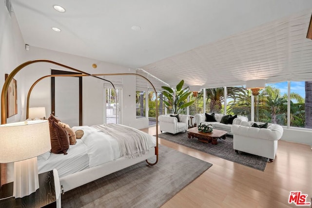 bedroom featuring lofted ceiling and hardwood / wood-style floors