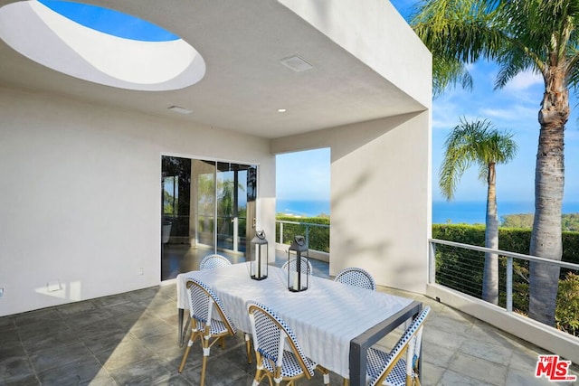 view of patio with a water view