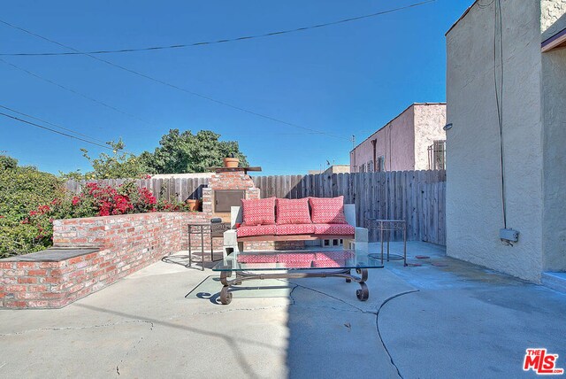 view of patio / terrace with an outdoor fireplace