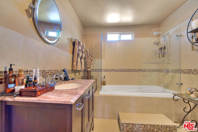 bathroom featuring tiled shower / bath combo, tile patterned floors, and vanity