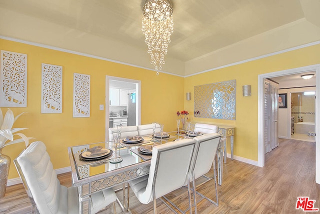 dining room featuring light hardwood / wood-style flooring and a notable chandelier