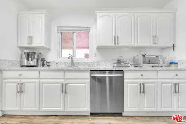 kitchen featuring light stone countertops, dishwasher, white cabinetry, and light hardwood / wood-style flooring