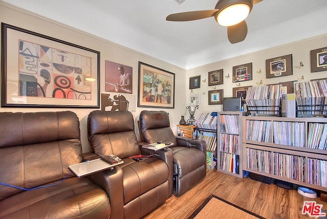 home theater room featuring ceiling fan and hardwood / wood-style floors