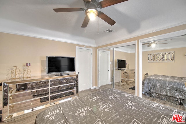 bedroom featuring ceiling fan, crown molding, a textured ceiling, and hardwood / wood-style flooring