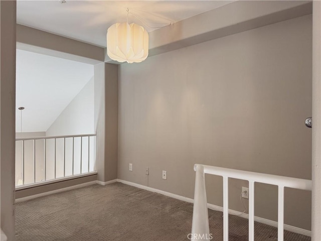 empty room featuring an inviting chandelier and carpet floors