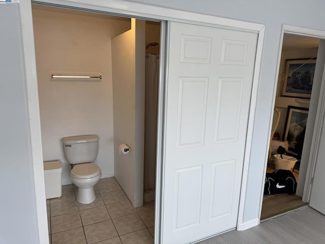 bathroom with toilet and tile patterned floors