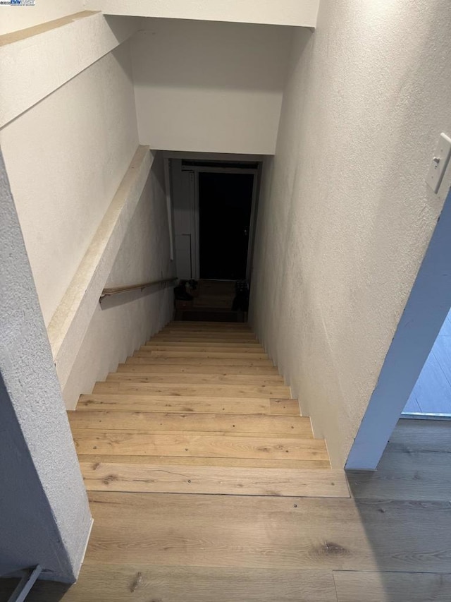 staircase featuring hardwood / wood-style floors