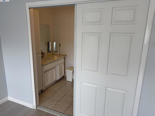 bathroom featuring toilet, vanity, and tile patterned floors